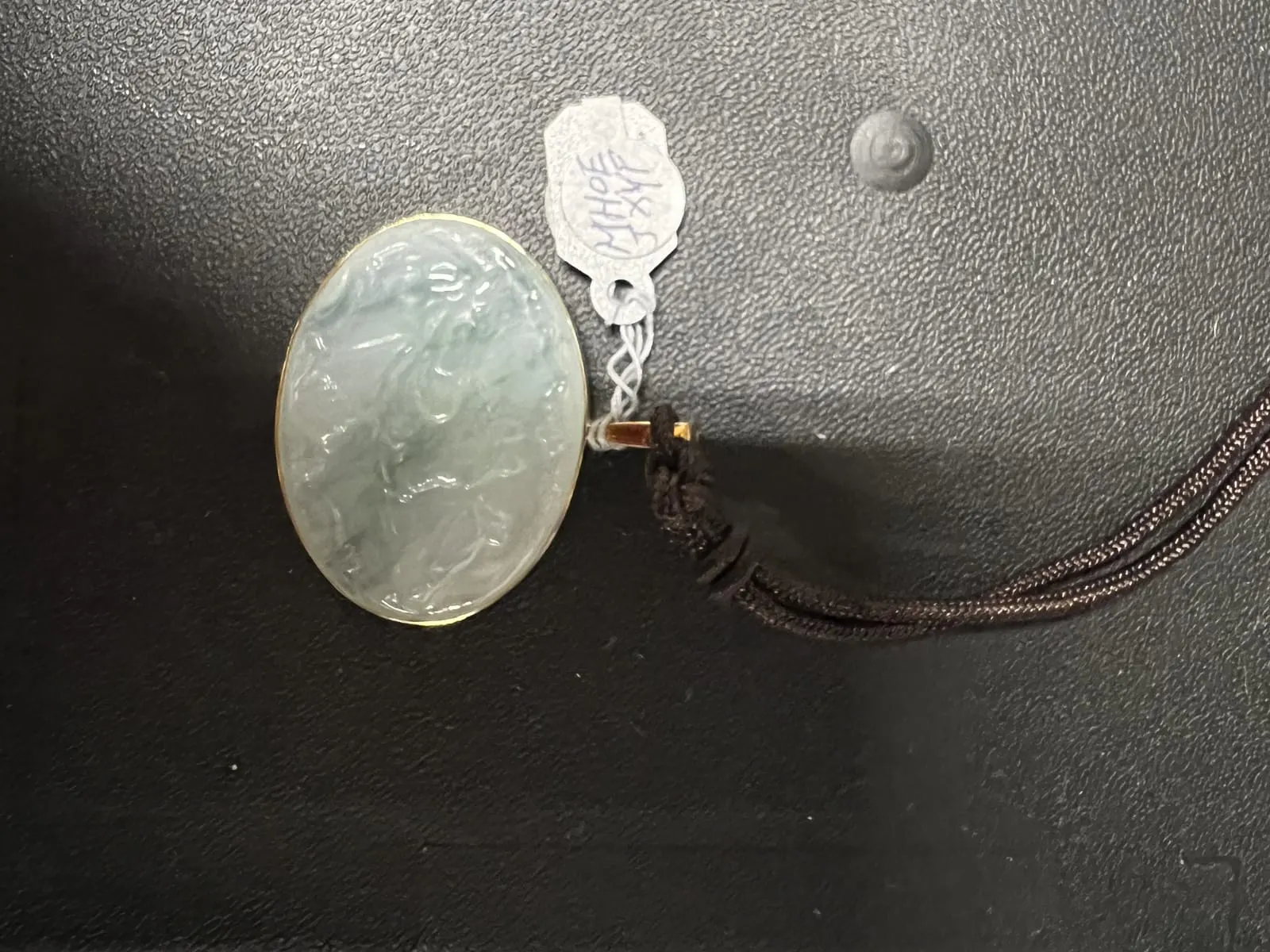 Carved Icy Jadeite Oval Pendant on Silk Cord